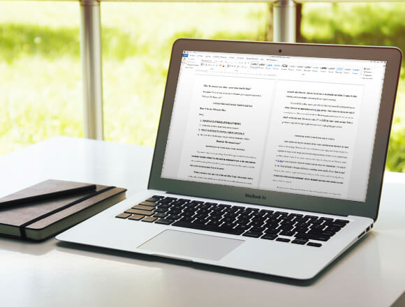 Writing an informal essay on a laptop at the Pro-Paper office